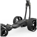 A golf push cart with three large wheels is positioned with the handle upright featuring a digital display and adjustable components designed for transporting golf bags on various terrains.