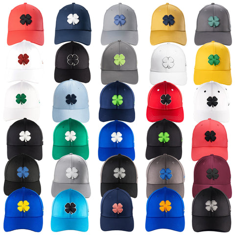 A variety of baseball caps displayed in multiple colors featuring a four-leaf clover design on the front. The caps are arranged neatly in rows with different color combinations.