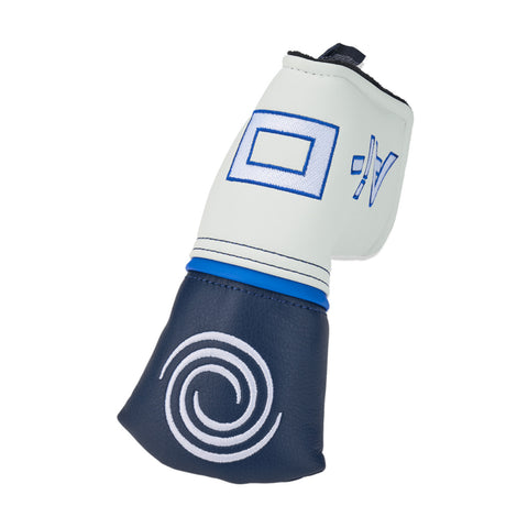 A golf club with a distinctive curved head is positioned upright against a neutral background featuring designs on the shaft and head that include a blue square and a swirl.