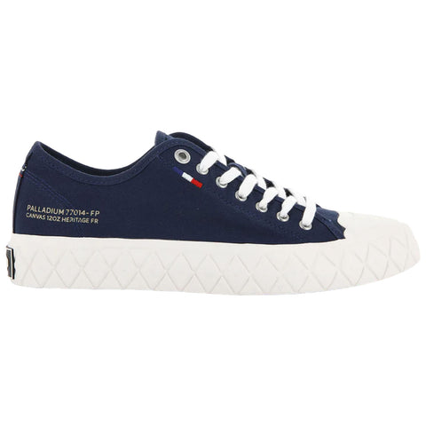 A navy canvas sneaker features a white rubber sole with a textured design and white laces the side shows branding and a small French flag emblem