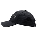 A black baseball cap with a glossy logo on the front is positioned slightly tilted to the right showcasing its curved brim and adjustable strap at the back.