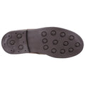 A brown shoe sole is displayed featuring various round studs for traction indicating it is designed for grip on surface likely suitable for sports or outdoor activities.