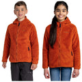 Two children wear bright orange fleece jackets with hoods and zip closures. They smile and stand side by side against a plain background, showcasing the jackets.