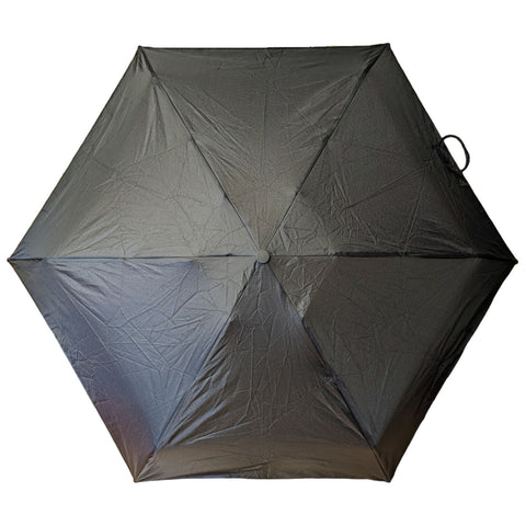 A black umbrella is open and fully expanded showcasing its hexagonal shape with a textured surface amidst a neutral background. It appears ready for use in rain or sun protection.