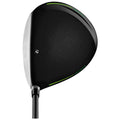 A golf driver featuring a black clubhead with a glossy finish and green accents is positioned upright showcasing its curved shape and sleek design against a plain background