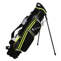 A black and yellow golf bag stands upright with extendable legs displaying multiple zippered compartments designed for holding golf clubs and accessories in a spacious outdoor setting.