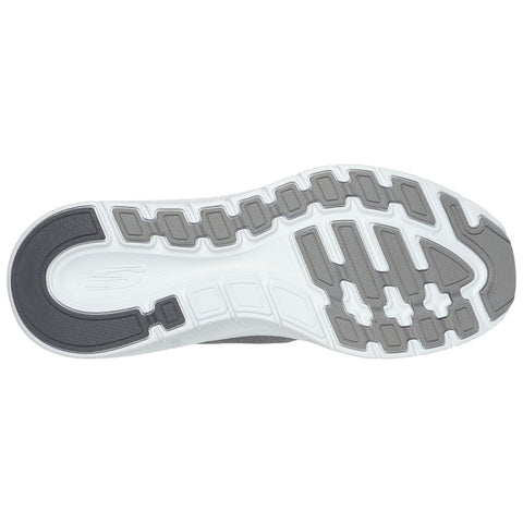 Athletic shoe sole displays patterned traction features. The sole is black and white with textured gray elements, designed for grip and stability on various surfaces.