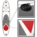 A paddleboard with a white body features a grey textured surface and red accents. It displays attachment points and a D-ring for securing items.