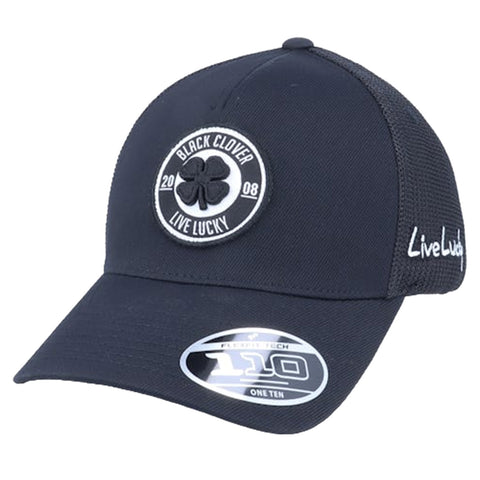 A black baseball cap with a circular patch featuring a clover design and the words Black Clover Live Lucky 2008 sits at an angle showcasing its embroidered details and brand sticker.