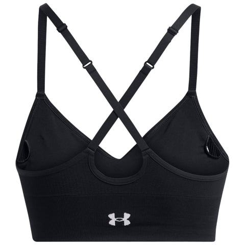 A black sports bra with a crisscross strap design features a circular cutout in the back and an Under Armour logo prominently displayed on the front band.