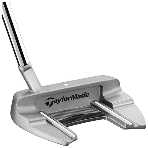 A silver golf putter with a flat face and two parallel grooves is positioned upright with a shiny metal shaft indicating potential use on a golf course or practice green.