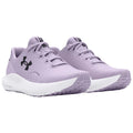 Purple athletic shoes with a textured upper and white sole are displayed side by side showcasing the lace-up design and prominent black logo on the side in a neutral background setting.