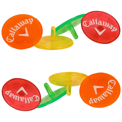 Colorful golf markers are arranged in pairs with visible branding. They are placed upright on a flat surface, suggesting use during a game or practice session.