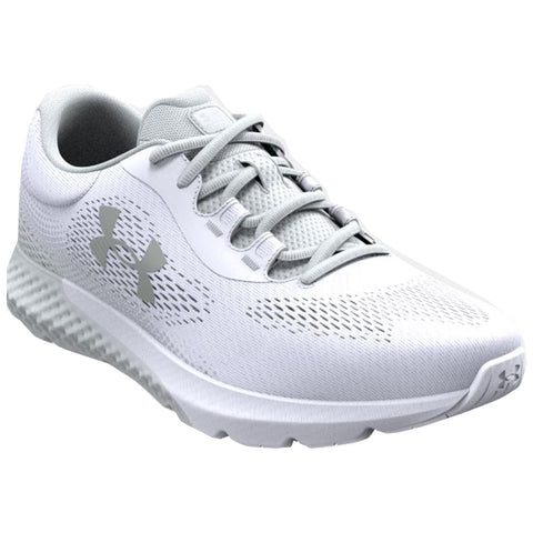 A white athletic shoe features a breathable mesh upper and lacing system on a textured sole designed for grip and support showcasing the Under Armour logo on the side