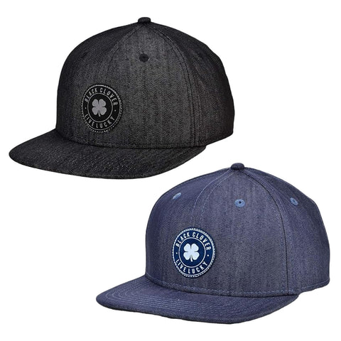 Two baseball caps are displayed side by side the cap on the left is black with a circular logo and the cap on the right is dark blue with a similar logo