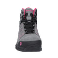 A gray hiking boot with pink accents is displayed front-facing featuring a textured surface and lacing system designed for outdoor activities in a rugged environment.