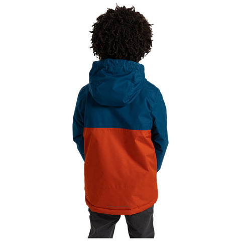 A child with curly hair wears a blue and orange jacket while standing with their back facing the viewer, possibly in an outdoor setting ready for activities.