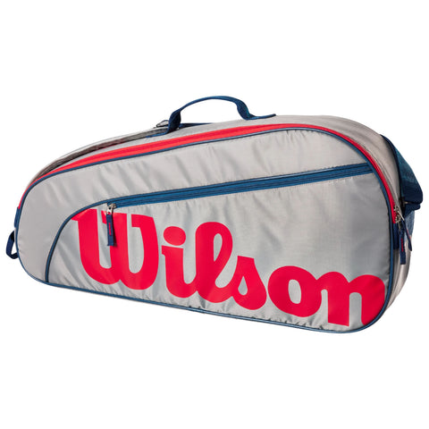 A gray tennis bag with a large red Wilson logo and blue accents is displayed. It features zippers and a handle, designed for transporting sports equipment.