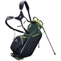 A golf bag with a green and black design features adjustable carrying straps and stands upright on two legs in a neutral setting, ready for use on a golf course.