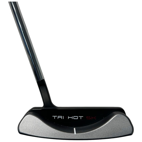 A golf putter rests vertically with a sleek, metallic head and a shiny shaft. The putter features the text "TRI-HOT 5K" on its face, suitable for use on a green.