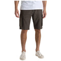 Brown cargo shorts are worn by a standing person who has hands at their sides in a casual indoor setting with a white t-shirt and white sneakers.