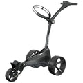 A black and gray golf push cart stands upright with three large wheels and an ergonomic handle at the top for guiding it across a golf course or similar terrain.