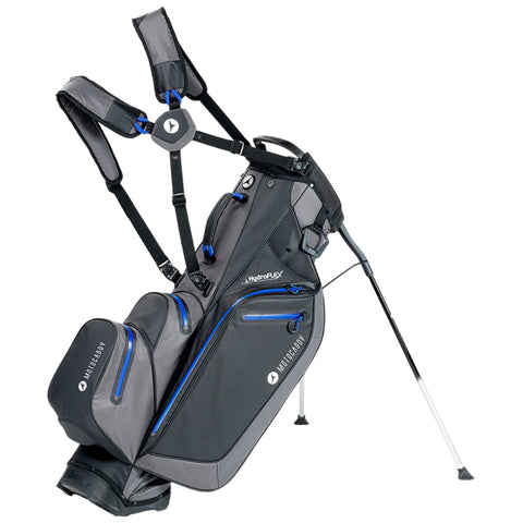 A golf bag with adjustable straps stands upright on its legs featuring multiple compartments and a modern design. It is primarily black with blue accents and functionality for ease of transport.