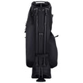 A black golf bag stands upright with clubs secured inside and a sturdy base. The bag features multiple compartments and straps for easy carrying on a golf course or practice range.