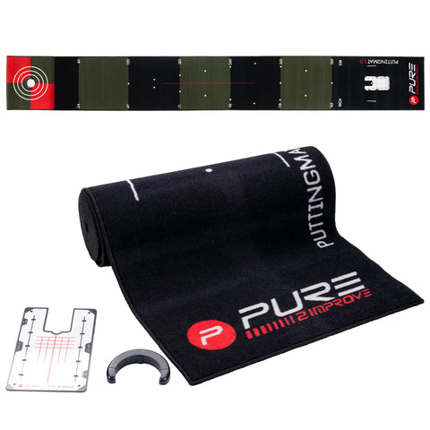 A black putting mat is unrolled featuring markers for distance and alignment. Accessories include a white alignment aid and a circular device, designed for training in a home or practice setting.