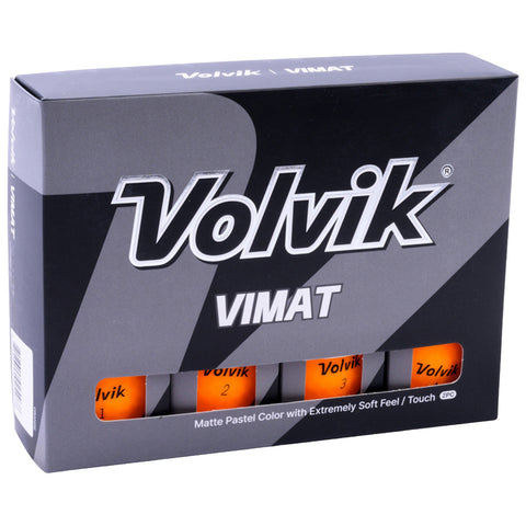 A box of colored golf balls is displayed with three orange balls partially visible through a window. The label indicates they are Volvik Vimat with a matte pastel finish.