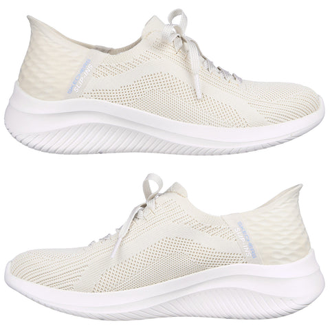 Light-colored athletic shoes with a breathable mesh upper and white soles are displayed from two angles emphasizing their slip-on design and textured heel section in a neutral setting.