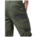 Green cargo pants with multiple pockets are positioned sideways showing the back features An individual’s hand rests on the waistband highlighting the practical aspects of workwear. The brand name Raptor is visible.