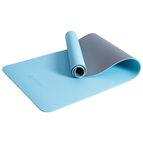 A blue yoga mat is partially rolled up with the gray underside exposed it is placed flat on a light surface suggesting preparation for exercise or yoga practice.