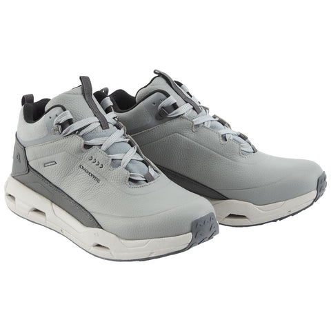 Two grey outdoor shoes are placed side by side on a flat surface featuring a textured upper material and contrasting rubber soles designed for traction and support during various activities.