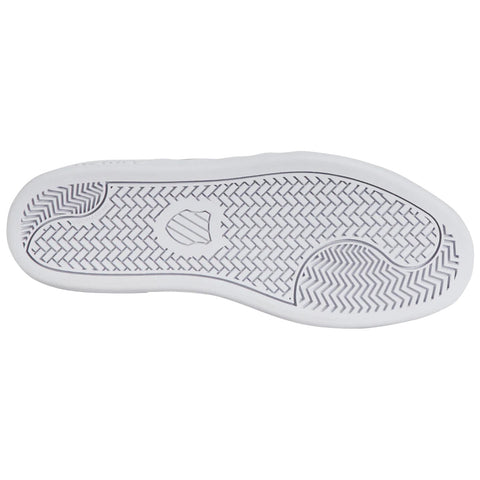 A white sneaker sole with a patterned tread design is displayed. The sole is oriented flat against a white background, emphasizing its curvature and grip features.