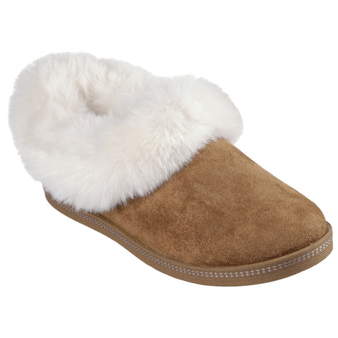 A brown slipper made of suede with a white faux fur trim sits on a plain background showcasing its soft texture and cozy design suitable for indoor comfort.