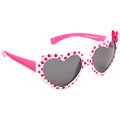 Heart-shaped sunglasses with a white and red polka dot pattern are positioned at an angle the pink arms feature a small bow illustrating a playful and stylish design