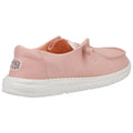 A pink slip-on shoe with a soft fabric upper sits on a light-colored speckled sole showcasing a casual design suitable for comfortable wear in casual settings.