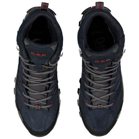 Two navy blue hiking boots are positioned side by side with laces threaded through hooks they feature a rugged sole and textile detailing designed for outdoor activities in various terrains.