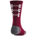 A burgundy sock features white bone-shaped patterns down the side with a gray heel and toe in a well-lit indoor setting showcasing its athletic design and vibrant color.