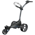 A golf push cart with a sleek design is stationary with three wheels at the base featuring large tires while a handle extends upward for grip in a smooth, outdoor environment.