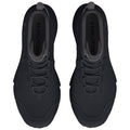 Two black athletic shoes are positioned side by side displaying a sleek design with a textured surface and lacing system suitable for outdoor activities in an indoor setting.