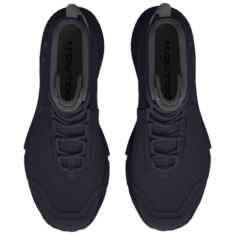 Two black athletic shoes are positioned side by side displaying a sleek design with a textured surface and lacing system suitable for outdoor activities in an indoor setting.