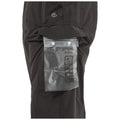 A pair of black pants has a transparent waterproof drybag attached to the side pocket displaying instructions for use including waterprooF seal and fill indicators for secure storage.