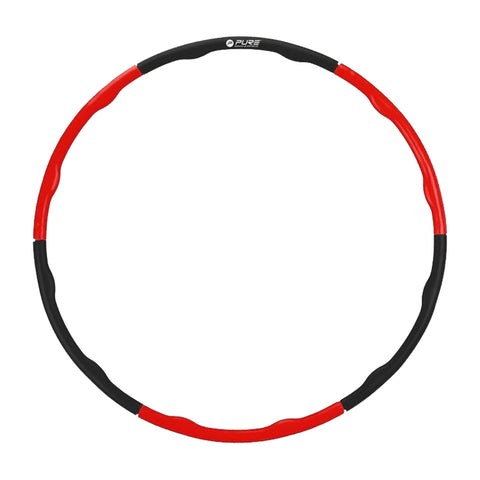 A circular hula hoop with a combination of red and black colors is displayed against a plain background suggesting potential for exercise or recreational use.