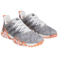 Gray athletic shoes with a textured upper and contrasting orange and white accents are positioned together on a plain white background showcasing their design and color details.