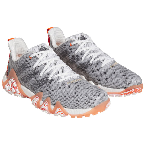 Gray athletic shoes with a textured upper and contrasting orange and white accents are positioned together on a plain white background showcasing their design and color details.