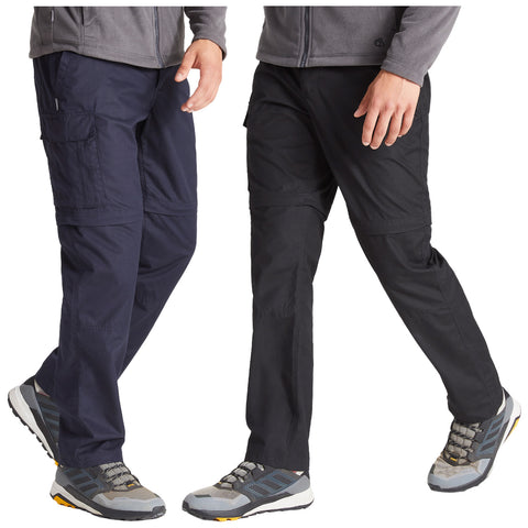 Two pairs of outdoor pants are shown with a person wearing each pair. One pair is navy blue while the other is black. Both are cargo style and paired with hiking shoes.