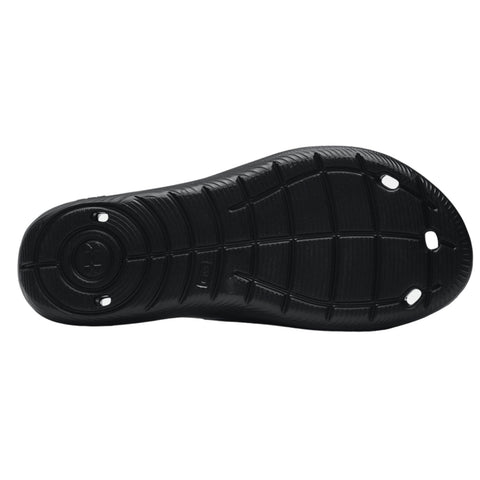 A black shoe sole rests flat showing its textured surface and pattern with circular and oval holes for traction designed for outdoor or athletic use.