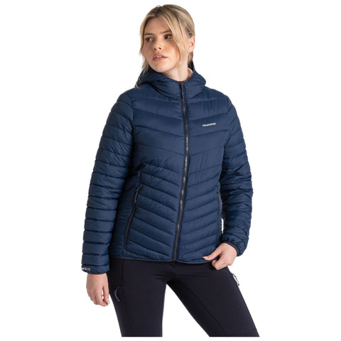 A person wearing a dark blue puffy jacket stands with their back facing the viewer in a neutral setting emphasizing the jacket's texture and design